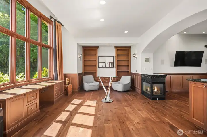 Stately office/study/parlor w/private powder room. Wall of wood-wrapped windows. Built-in desk & shelving. Cozy 3-sided gas fireplace.