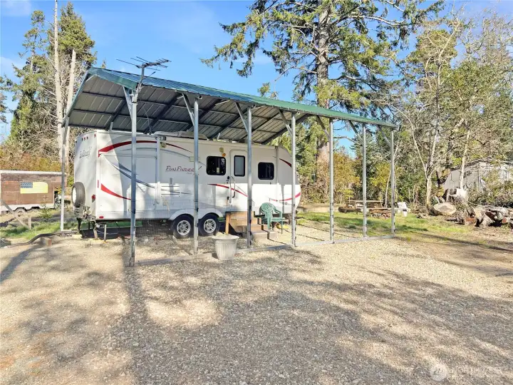 Metal carport and 2012 Fun Finder travel trailer to stay
