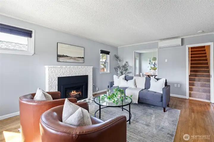 Enter into the welcoming living room which as both a new gas insert fireplace for warmth and coziness, as well as a mini split heating and cooling system.