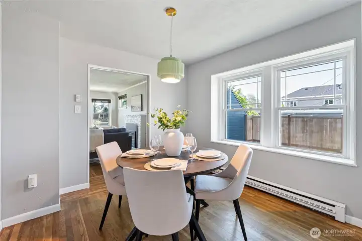 Bright dining room between the living room and the kitchen.