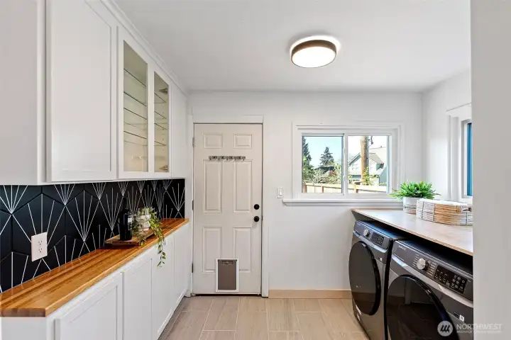 Additional cabinet space with a brand new washer and dryer conveniently located off the kitchen.