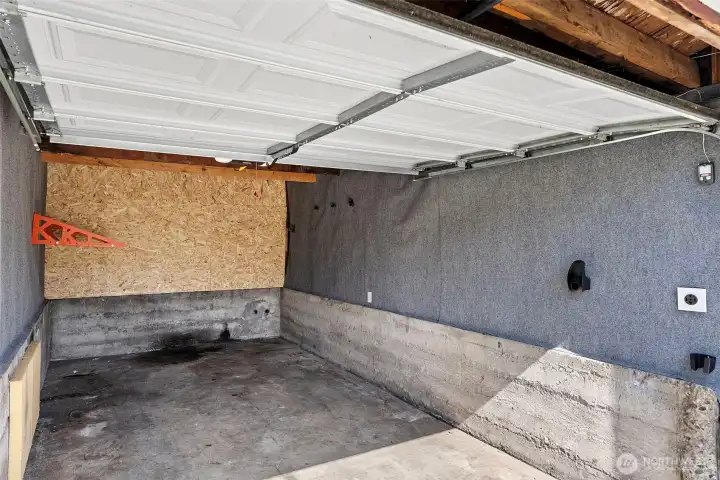Garage fitted with electrical vehicle charging.