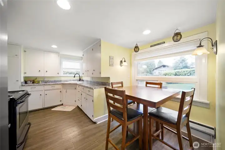 Kitchen with built-in pantry and dining nook.