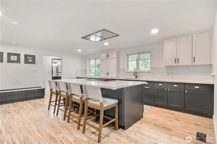Gorgeous gourmet kitchen with huge quartz island, recessed lighting, tons of natural light an abundance of counterspace and cabinets.
