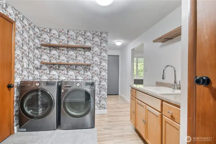Laundry room with sink and tons of storage.