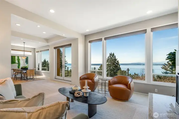 A striking wall of windows with Bluetooth blinds floods the space with natural light and frames the breathtaking views.