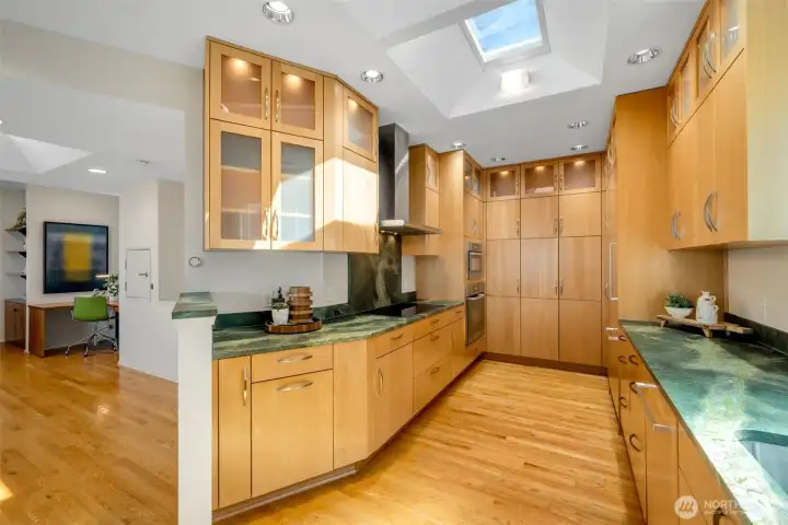 Rich leathered-finish Italian granite countertops, high-end appliances, and custom cabinetry with abundant storage come together in a kitchen designed to inspire the home chef.