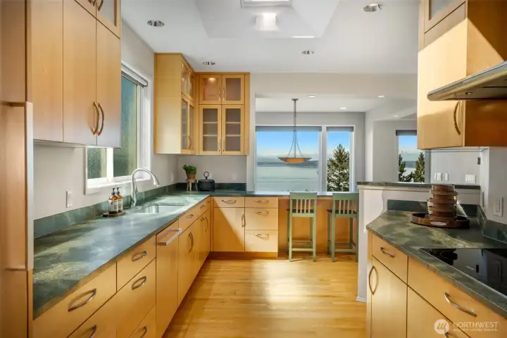 A four-seat breakfast bar overlooks the dining room, offering the perfect spot to enjoy morning coffee and casual meals.