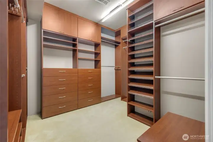 Generous walk in custom closet.
