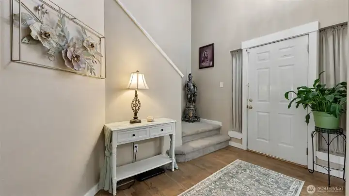 Inviting entryway with stairs and main floor bathroom.