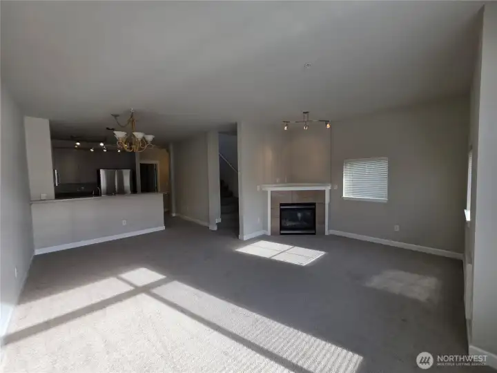 Spacious living room with gas burning fireplace, dining area and updated kitchen.