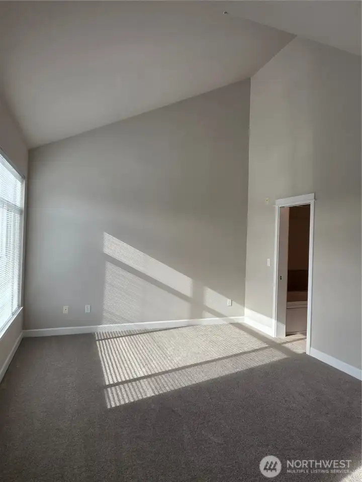 Soaring vaulted ceilings in primary bedroom