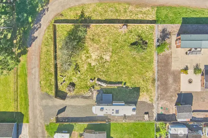 Bird’s-eye perspective showcasing the full footprint of this corner parcel with established fencing and defined boundaries.