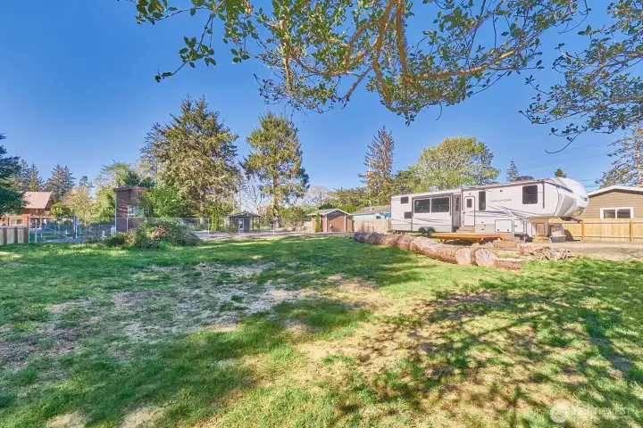 Spacious, open lot with RV visible in the background (available separately). Don't let the summer get away from you - camp now while you make future plans!