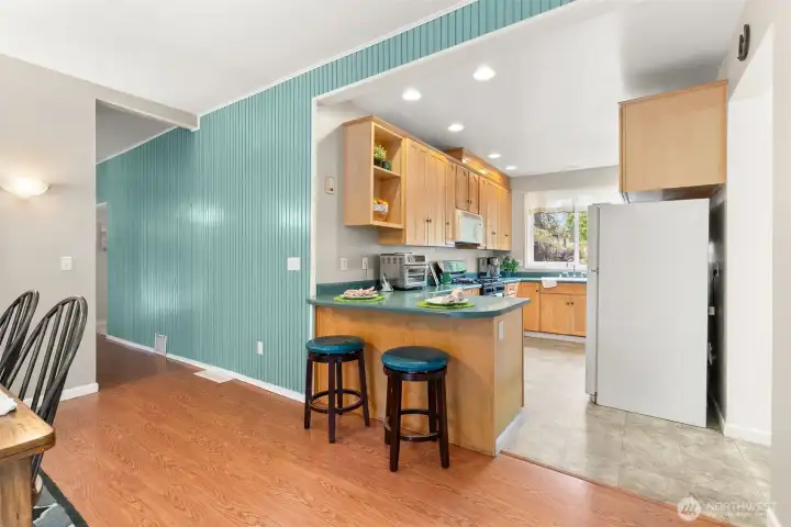 Open kitchen layout with breakfast bar seating and easy flow into the dining and living spaces.
