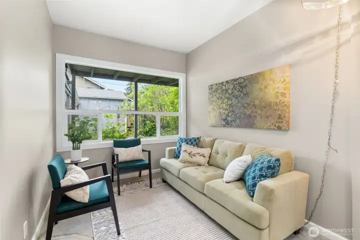 Cozy sitting area off the kitchen and dining space, perfect for relaxing or quiet mornings at home.