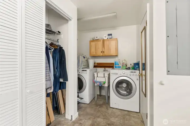 Spacious utility and laundry area with added organization space and convenient adjacent bath access