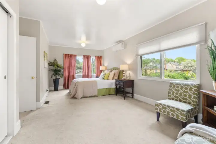Expansive primary bedroom offering a peaceful retreat with ample space for a sitting area or additional furnishings