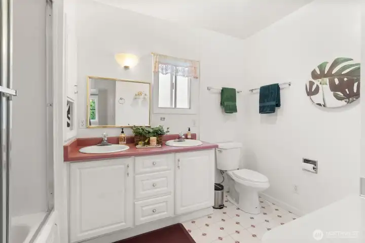 Spacious primary bath featuring dual vanities, generous storage, and a functional layout.