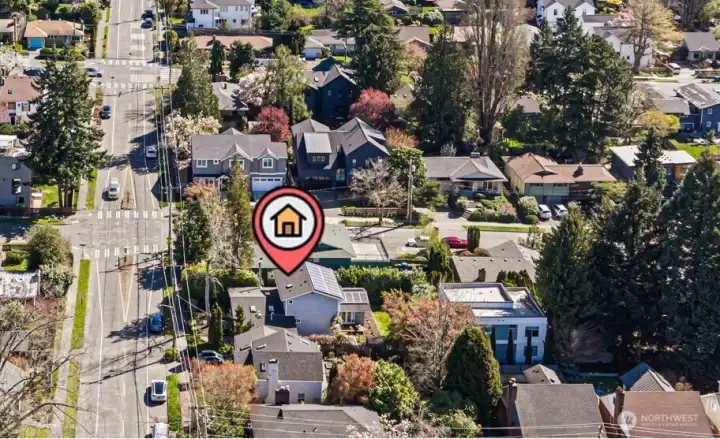 A closer view of the home with its extensions and the treat tree-lined neighborhood.