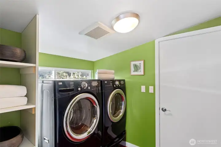 Utility and Laundry Room - Featuring a tankless Navien water heater, Carrier furnace, LG Tromm Steam Washer and LG Tromm Ultra Capacity dryer.