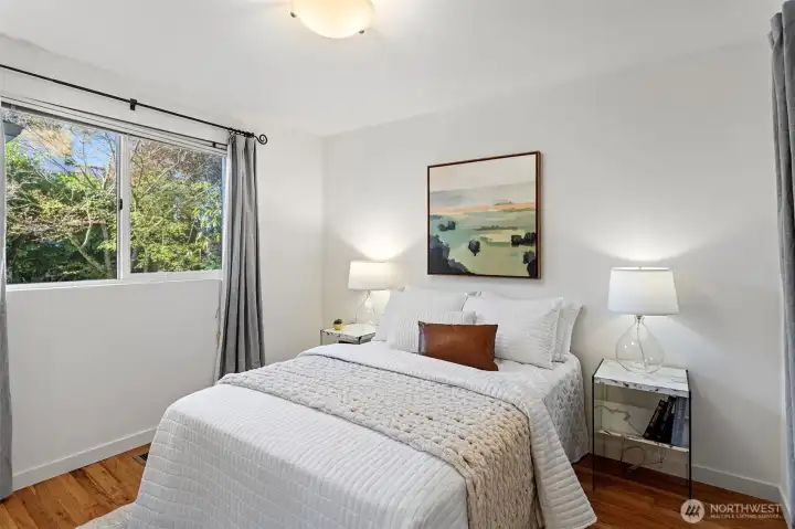 Bedroom 2 on main level - The only original bedroom left!  Hardwood floors, closet space and a gib window overlooking the garden area. Freshly painted with its own dedicated bathroom.