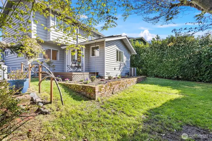 The south facing backyard also features raised garden beds and a large lawn area.