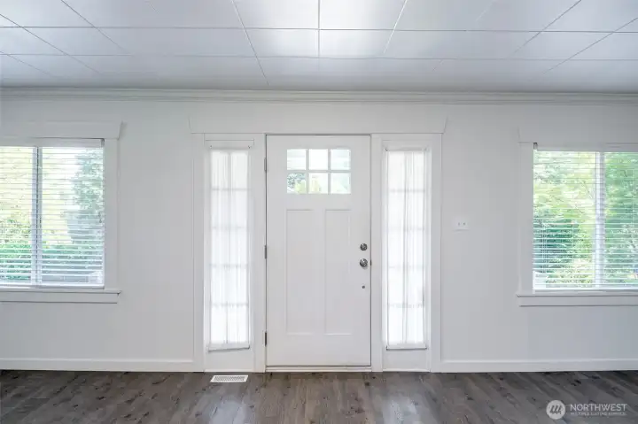 Charming front entry Door into home allowing natural light in family room