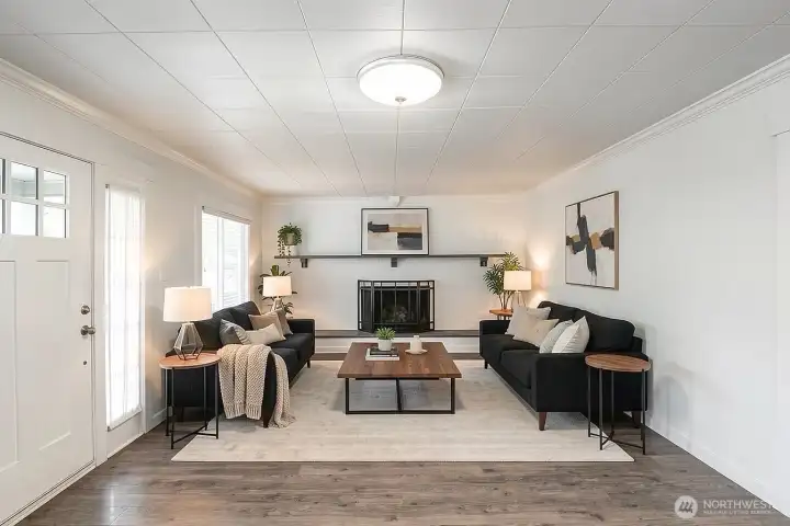 Family room with wood burning fireplace (virtually staged).