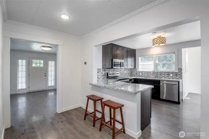 From wide hallway into kitchen and family room