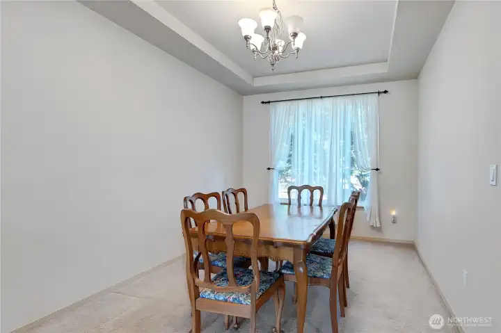 The dining room is super sized. Coffered ceiling and newly painted walls waiting for your touches