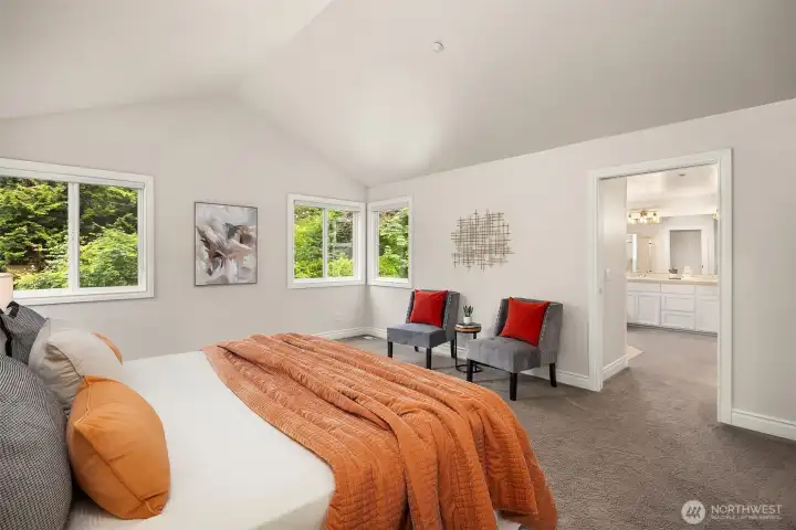 Primary bedroom features double door entry, vaulted ceilings and large windows. Primary bedroom features double door entry, vaulted ceilings and large windows.