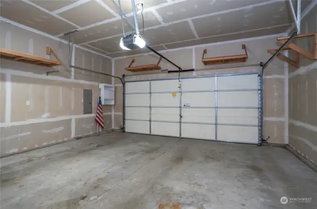 Two-car garage with convenient shelving.