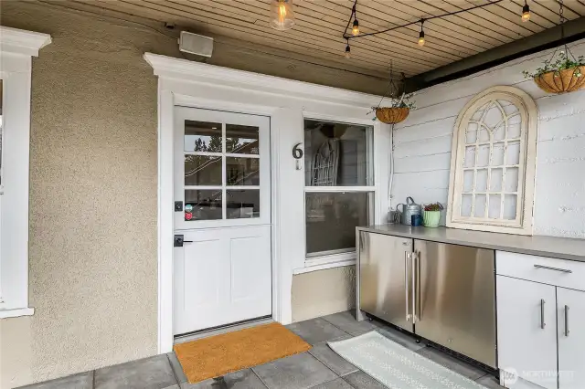 Outside storage and stainless serving area by the front door.