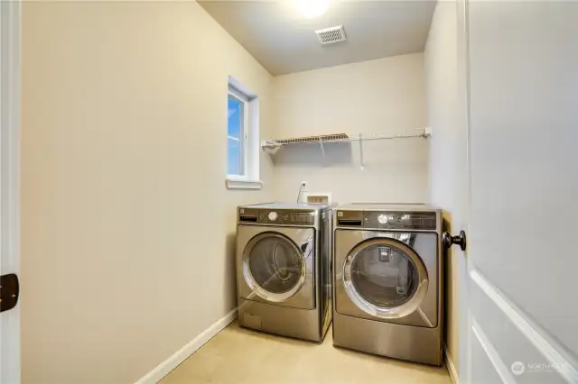 Upstairs laundry is located next to the primary bedroom