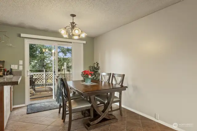 Dining area with slider to deck and backyard.