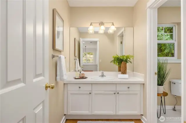 The shared bathroom on the upper floor with a door separating the vanity for shared use.