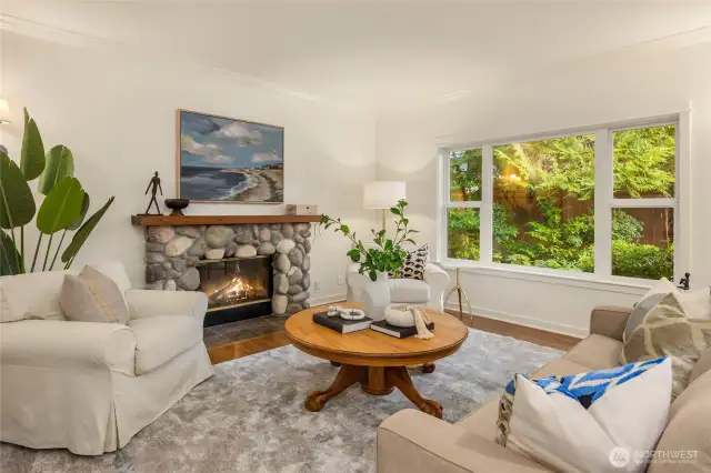 The family room is warm and cozy with a wood burning fireplace and views over the greenery of the back yard.