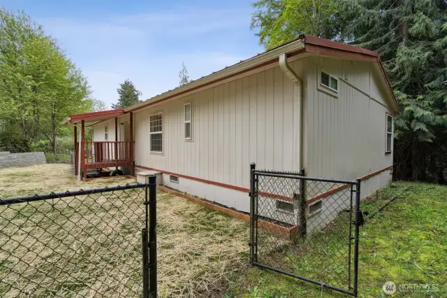 Back of the house and newly planted grass in the side yard