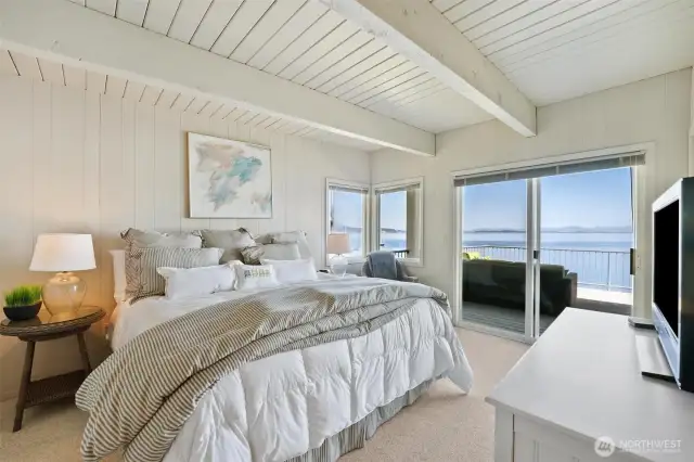 The main floor primary bedroom has deck access and its own half bath.