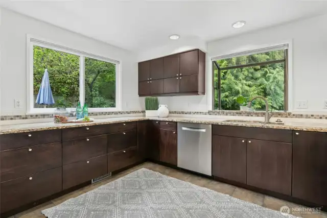 Lots of cabinets and counter top space, including a fabulous garden window over the sink in this good sized kitchen.
