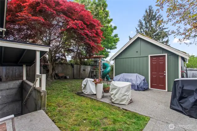 Fully fenced back yard, with one car garage