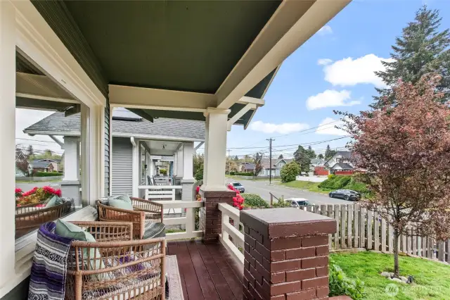 The front porch overlooks the fully fenced front yard