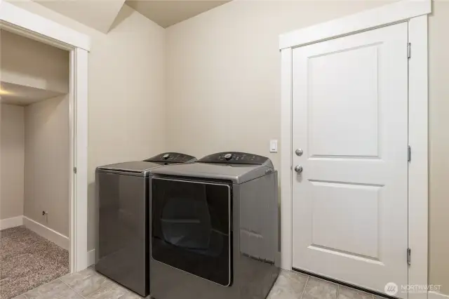Laundry/mudroom just off the garage. Expansive under-stairs closet to the left. Washer & dryer stay!