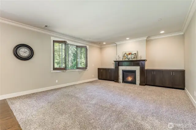 Living room has built-in storage cabinets. Custom shutters throughout the home!