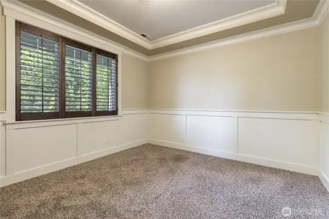 Main floor office with wainscoting and tray ceiling