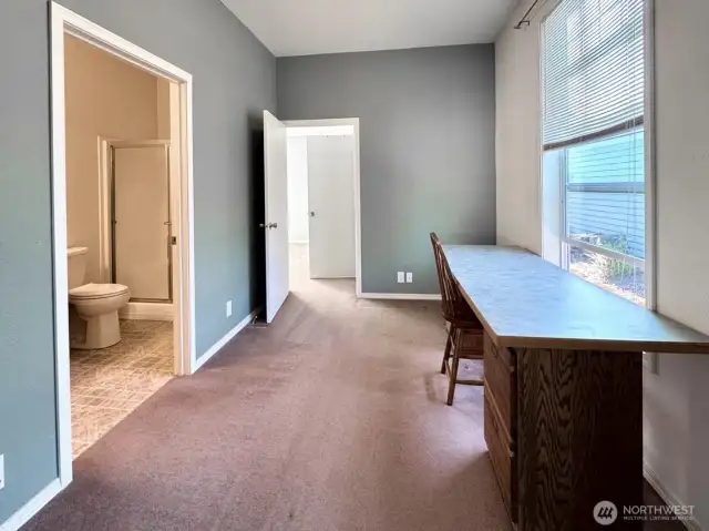 Office space, primary suite beyond.