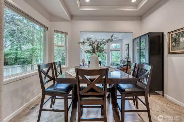 Formal dining with herringbone hardwood floor pattern right off formal living room.