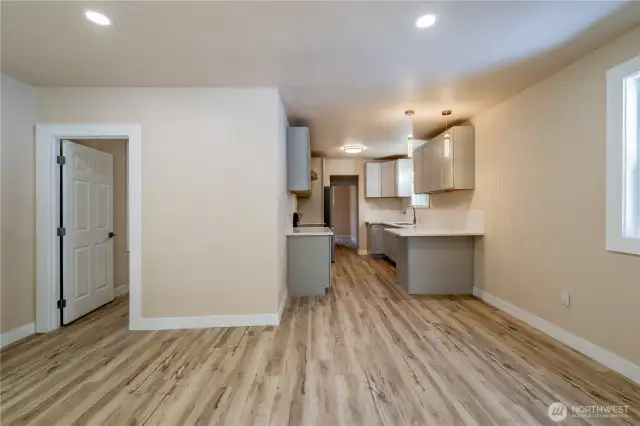 As you walk in the house, left door is bedroom, kitchen straight ahead