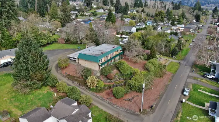 View of Fourplex with duplex partially obscured by tree to left.